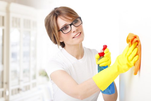 Cleaner washing a shopfront window in Barnet