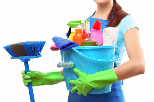 Trained cleaner using protective gloves during a Barnet cleaning task